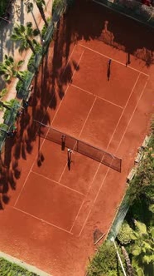 Vertical Video PalmCourt Rivalry Aerial View of Intense Tennis Matches
