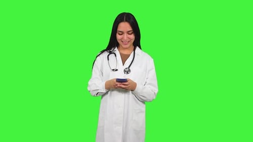 Latin Female Doctor Using Smartphone on Green Screen