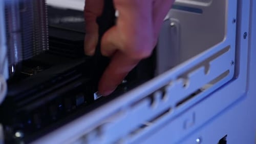 Closeup Hands of Unrecognizable Technician Male Plugging in CPU Power Cable While Assembling Modern