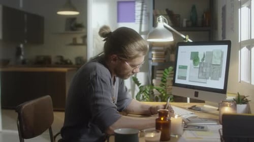 Designer Working at Computer in Home Office