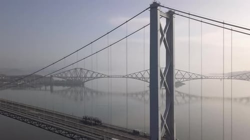 Imágenes aéreas del antiguo puente de Forth Road con el puente ferroviario de Forth al fondo sobre un sol