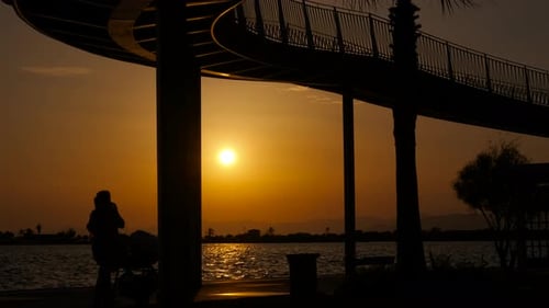 Fire Sunset Against Ocean Shore Silhouette
