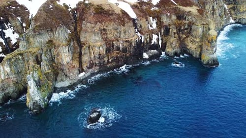 Flying Over Rocky Coastline Rocky Coast of the North Atlantic Ocean in Iceland