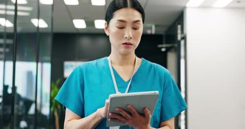 Asian woman, nurse and walking with tablet in corridor for medical research