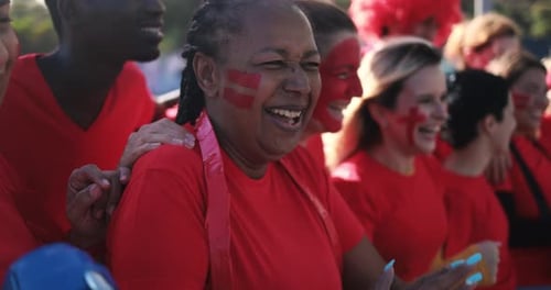 Happy Sports Fans Cheering and Clapping at Game