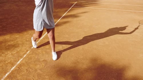 Legs of Tennis Player on Orange Clay Tennis Court During the Game