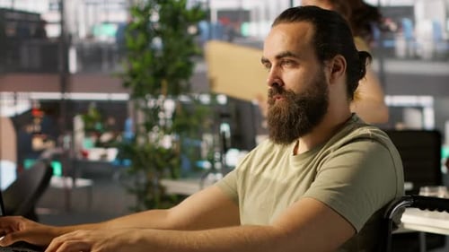 Man in Wheelchair Working at Modern Office