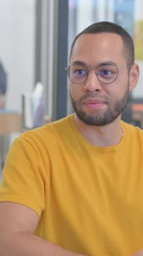 Close up of Mixed Race Man Talking with Creative Teammate, vertical video