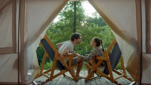 Romantic Couple Kissing in Glamping Tent in Forest