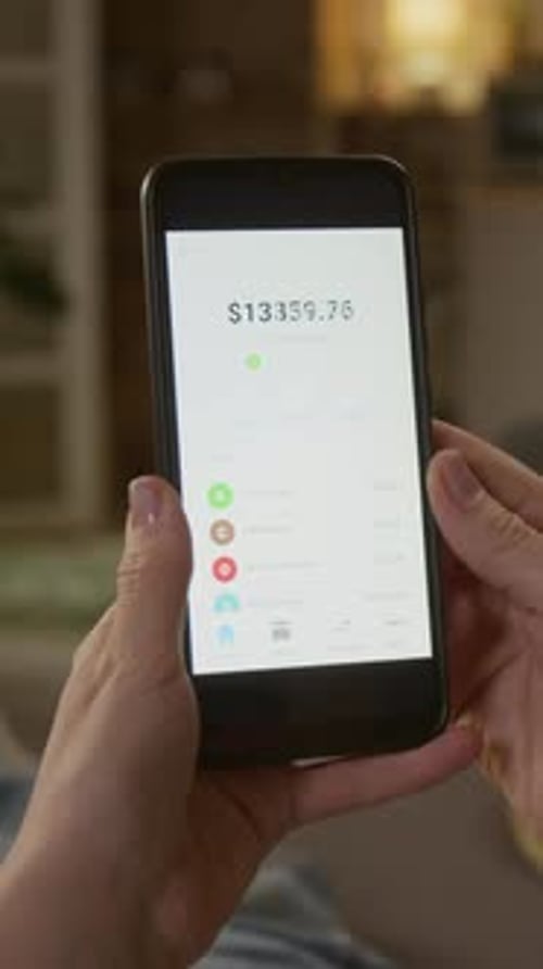 Vertical of Female Fraud Victim Staring at Money Disappear from Mobile Bank App