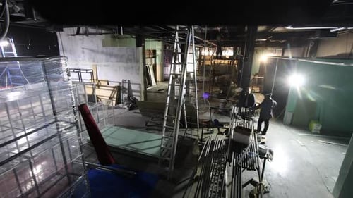 Indoor Space Undergoing Construction With Ladders and Scaffolding