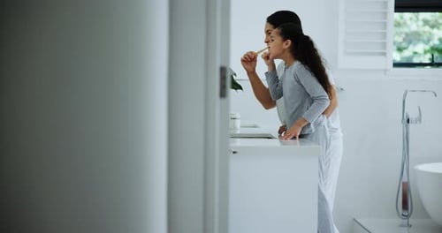 Woman and Child Brushing Teeth in Bathroom