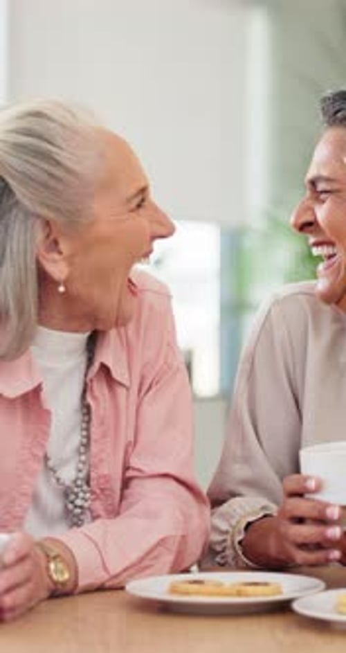 Three Senior Women Laughing Over Coffee and Pastries