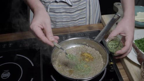 Adding spices to pan with cafe paris butter mix, meat sauce