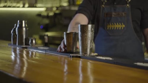 Man Shaking a Cocktail Shaker at a Bar