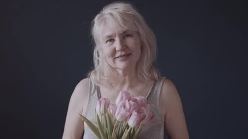 Smiling Woman Holding Pink Tulip Flower Bouquet