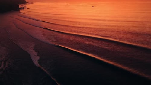 Amazing Warm Sunset or Sunrise and Ocean with Silhouette of Perfect Waves in Bali