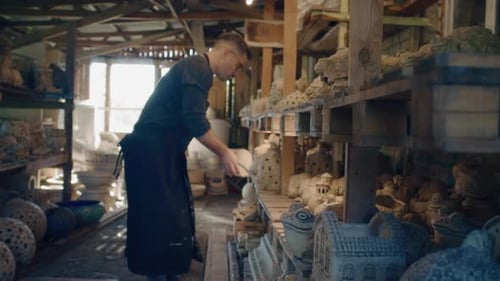 Male Ceramist Places Beautiful Hand Made Clay Sculptures in a Ceramic Workshop