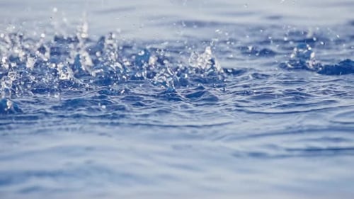 Water Droplets Creating Ripples on a Calm Surface