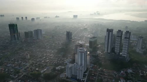 A city with a foggy sky and tall buildings. Aerial view Larkin, Johor
