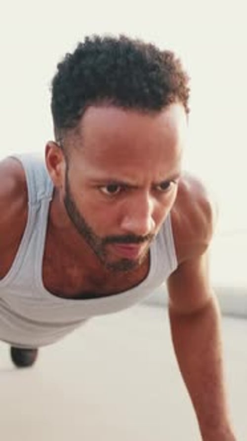 Close up, young athlete doing workout, push ups on the embankment