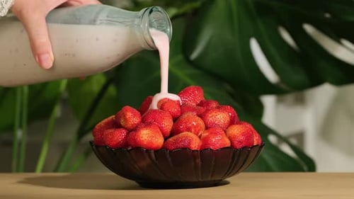 Strawberry. Yogurt pours on organic fresh red strawberries