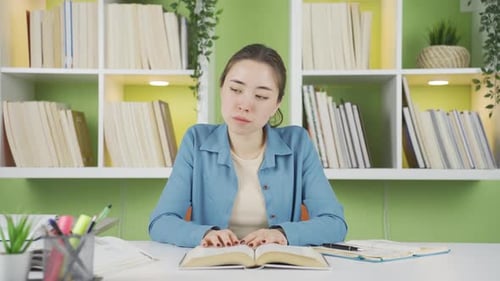 Female Student Studying at Desk With Books