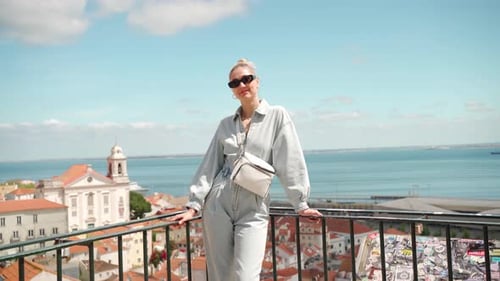 Woman Posing on a Balcony Overlooking City and Sea