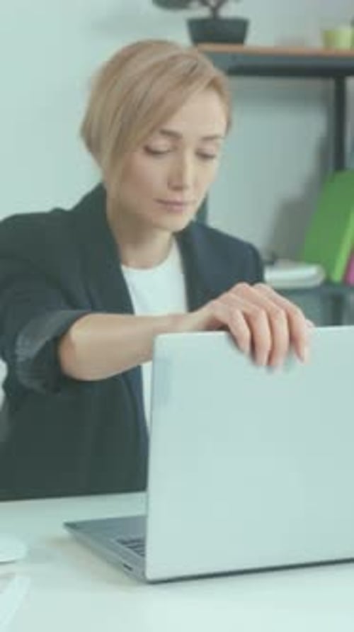 Calm Analyst Analyzing Spreadsheets at Desk Concentrated Professional Examining Data with Neat