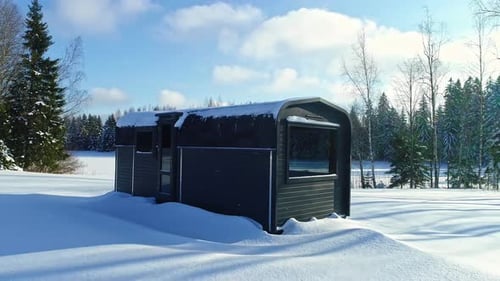 Cabin Retreat in Snowy Woodland Landscape