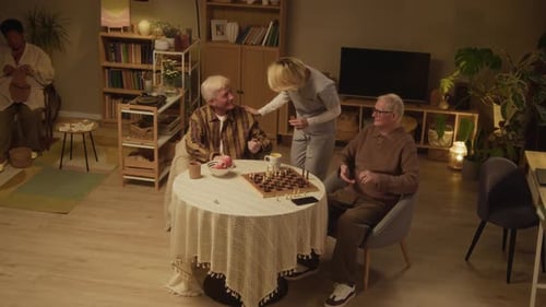 Female Caregiver Giving Evening Pills to Nursing Home Residents