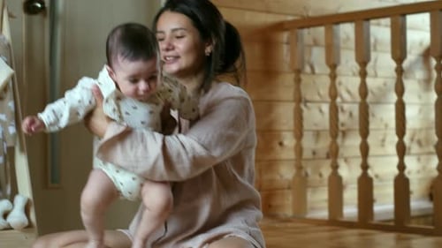 Mother and Baby Girl in Cozy Home Interior