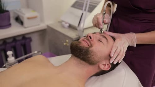A Man is Enjoying a Soothing and Relaxing Skincare Treatment at a Luxury Spa