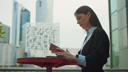 A Businesswoman is Preparing for Negotiations By Writing Documents