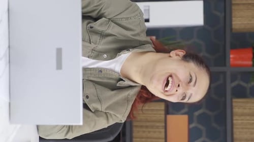 Laughing Woman Using Computer at Desk