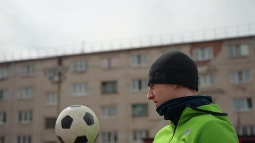 Man Spinning Soccer Ball on Finger Outdoors