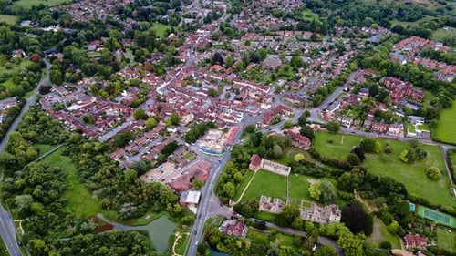 aerial drone shot high angle over Bishops Waltham town village with roads in autumn at sunset