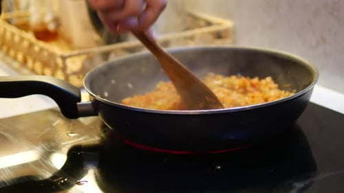 Stirring Vegetables in Frying Pan on Stove