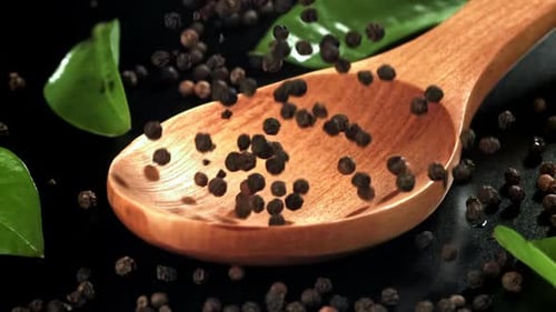 Black Pepper Falls on a Wooden Spoon Filmed on a Highspeed Camera at 1000 Fps