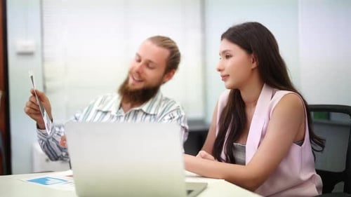 Creative Colleagues Collaborating on Laptop at Modern Office