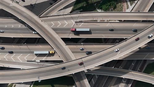 Top Down Drone Wide View on Road Intersection with Traffic on Multiple Flyovers