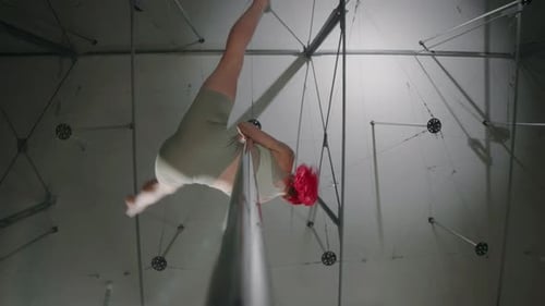 Bottom View of Red Haired Woman Pole Dancing in Studio