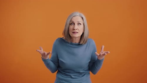 Senior Woman Looking Shocked with Expressive Gestures