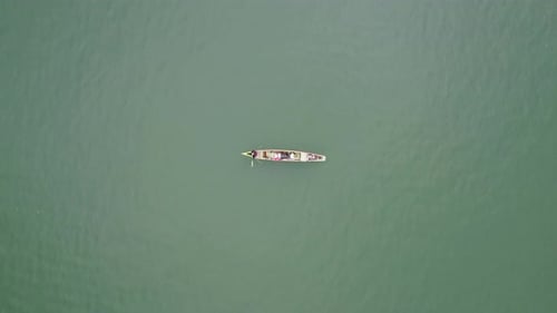 Aerial view of fishing boats sailing out to sea in search of fish