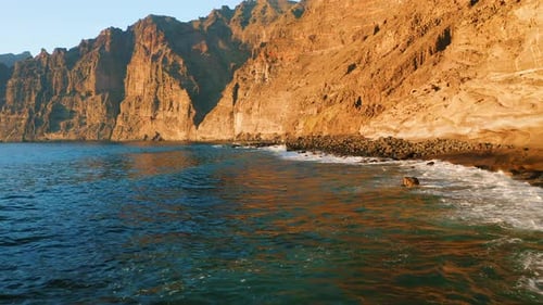 Small Grey Sandy Rocky Beach Backed By Steep Cliffs Los Gigantes Playa De Los Guios in Tenerife