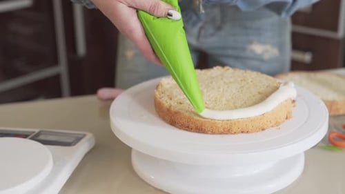 Close up video of a woman making a cake