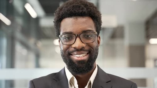 Smiling Businessman Wearing Glasses in Modern Office