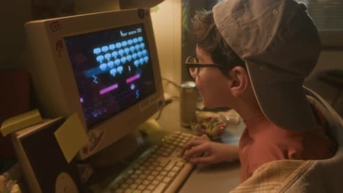 Child Playing Retro Video Game on Old Computer