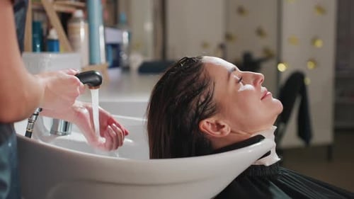 Woman Getting Hair Washed at Hair Salon