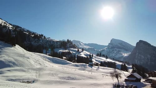 Ski and sledge slopes in the Swiss Alps on a sunny day.